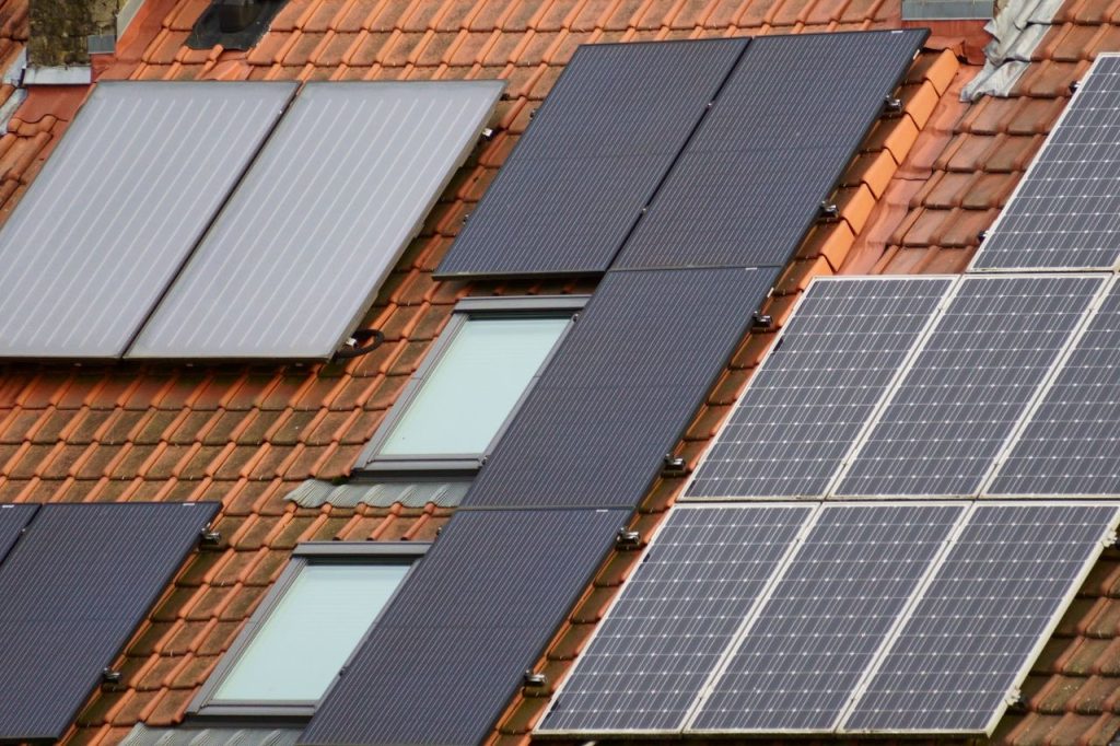 efficient-rooftop-solar-panel-installation-30440447 Close-up of solar panels on a tiled roof, showcasing sustainable energy solutions.